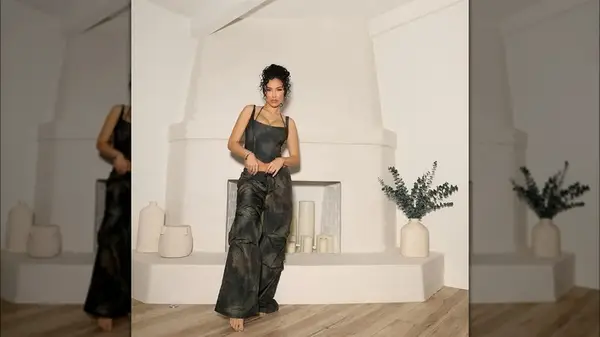 Bre Tiesi posing in front of a minimalist structure