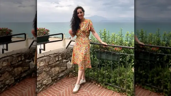 Woman in floral dress and sneakers