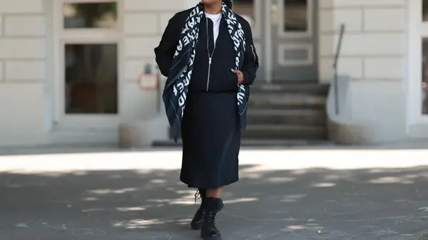 model outside in black silk skirt