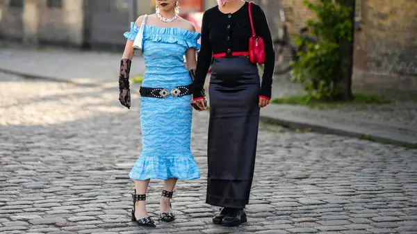 two models holding hands wearing silk
