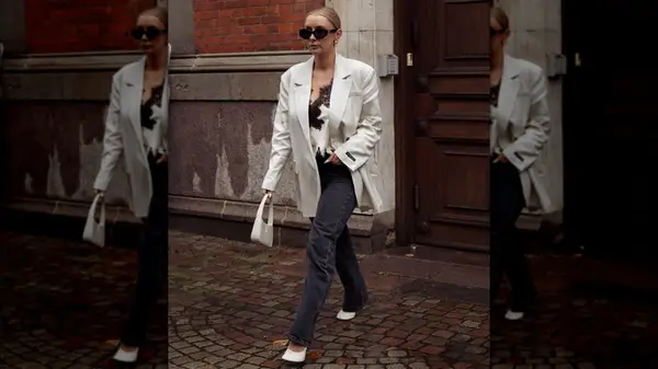 Woman in a blazer and black jeans 