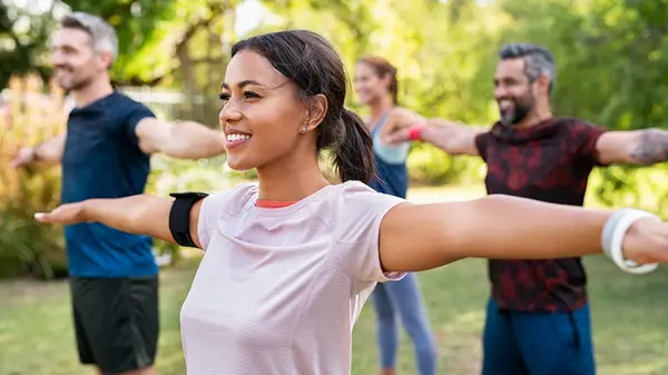 People smiling at outdoor workout class