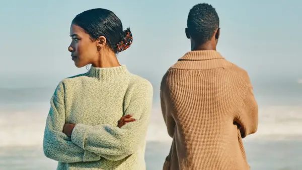 Disappointed couple on beach
