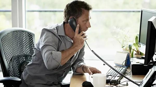 Man on phone at desk