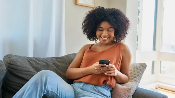 woman texting someone from her home