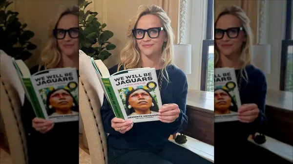 Reese Witherspoon in a photo on Instagram holding the book We Will be Jaguars