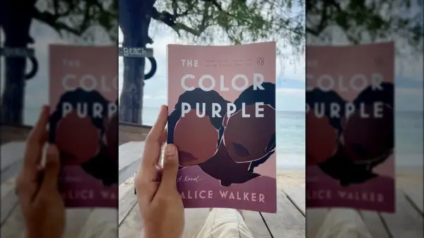 A hand holding up a copy of 