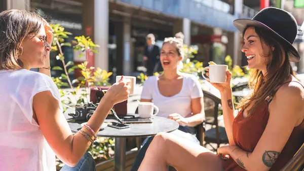 three women talking at table