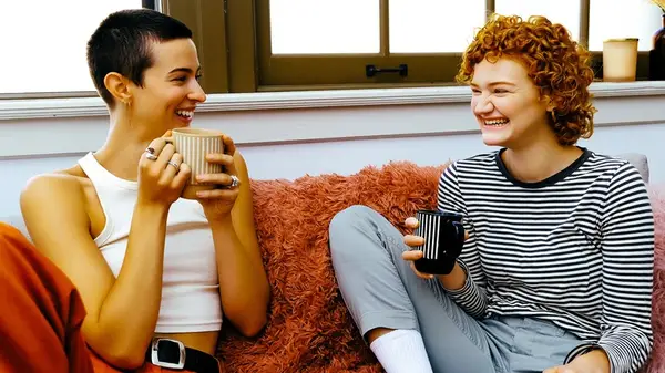 two people in a conversation smiling