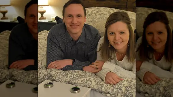Ryan and Jennifer Cmich smiling on a bed with LoveSync buttons