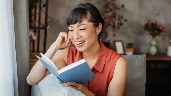 Smiling woman reading book