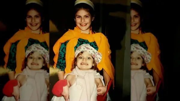 A young Alexandra Daddario with her little sister