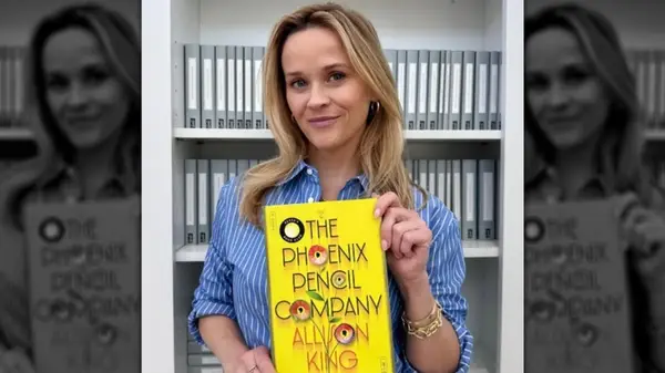 Reese Witherspoon holding 