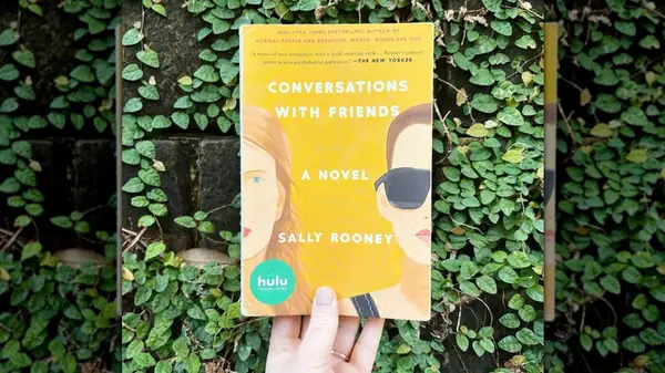 A hand holding up a copy of 