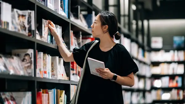 Woman looking at books