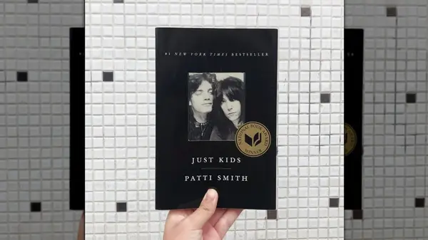 A hand holding up a copy of 