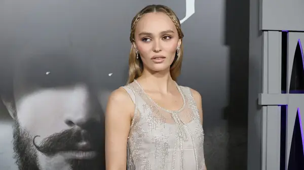 Lily-Rose Depp looking serious in grey at a premiere