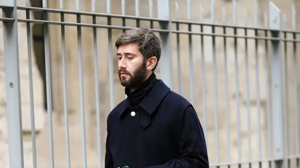 Man dressed in all black walking