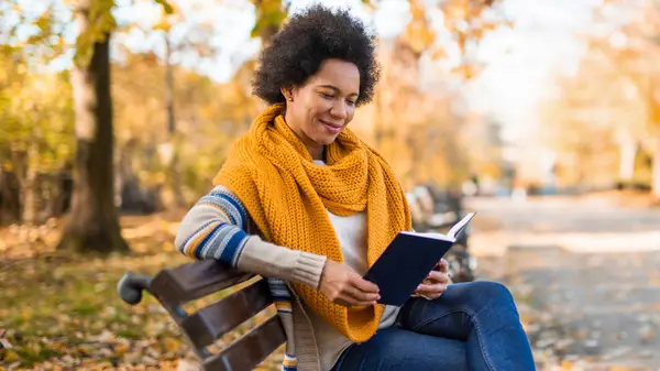 Woman reading on a park bench