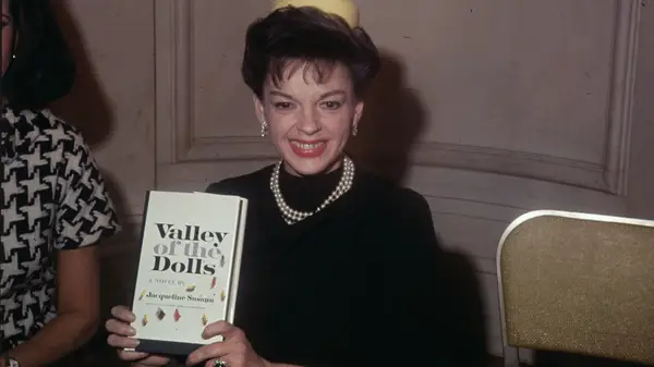Judy Garland holding Valley of the Dolls by Jacqueline Susann