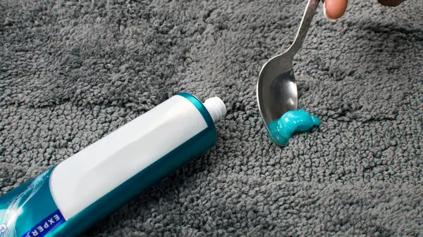 Scraping toothpaste off carpet