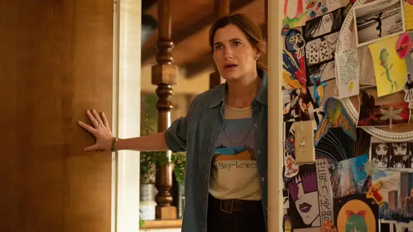 Kathryn Hahn standing in the doorway of a bedroom looking shocked