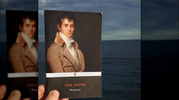 A hand holding a copy of 