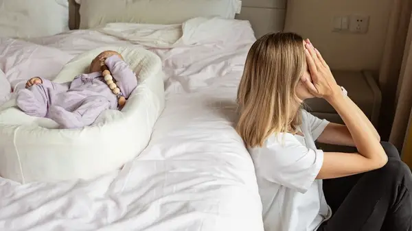 A tired mother with a baby