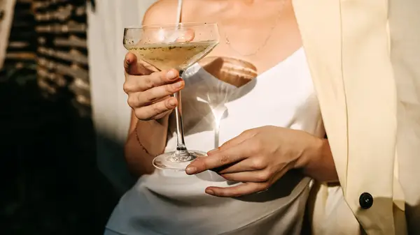 woman holding champagne coup