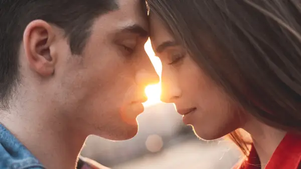 Man and woman with eyes closed, faces touching