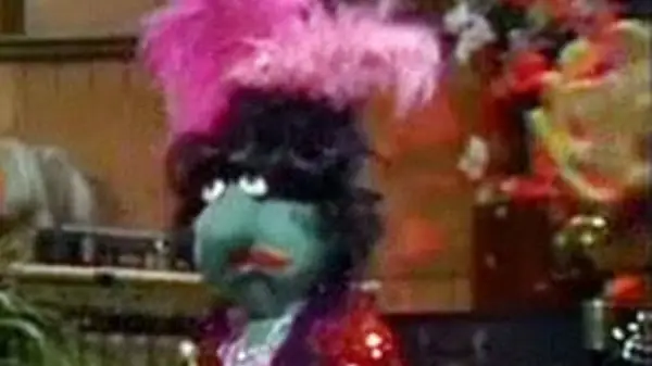 green muppet with pink hair