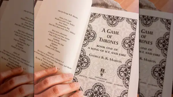 A hand holding open a copy of 