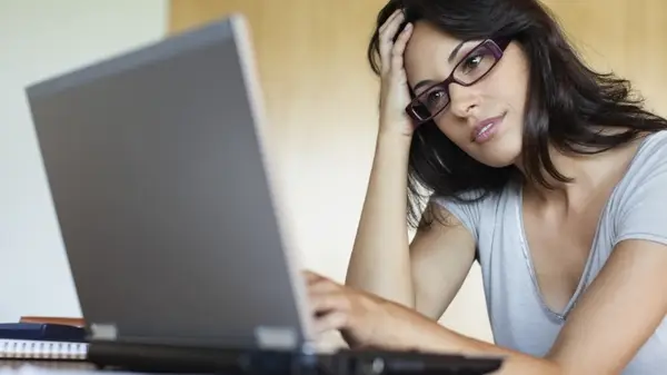 Woman looks at laptop