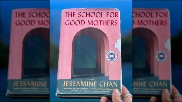 A hand holding up a copy of 