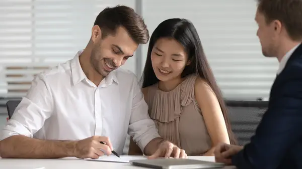 Couple signing papers
