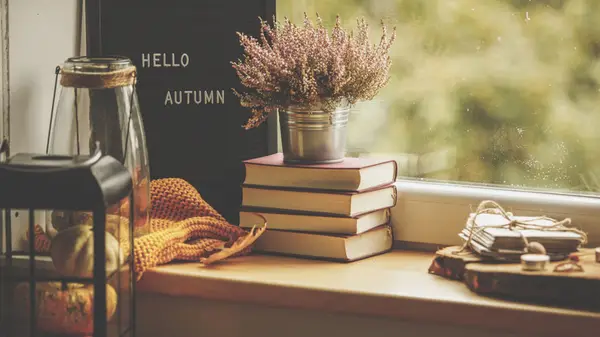 Cozy books stacked next to a sign reading 