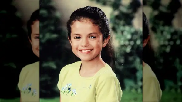 Selena Gomez as a young girl smiling