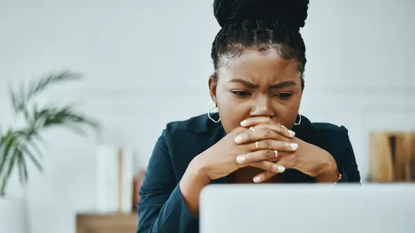 Woman looking confused at computer