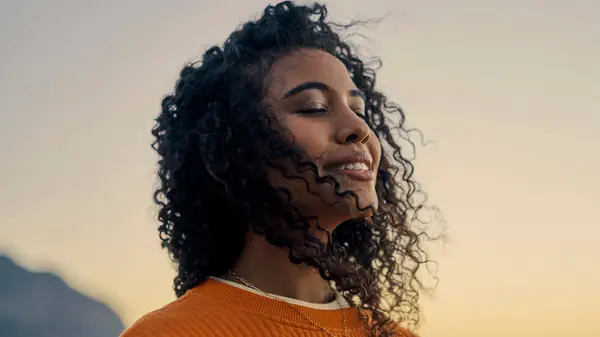 Woman outside smiling peaceful