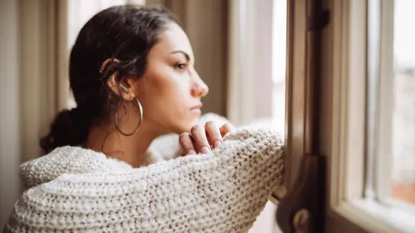 Woman looking out window