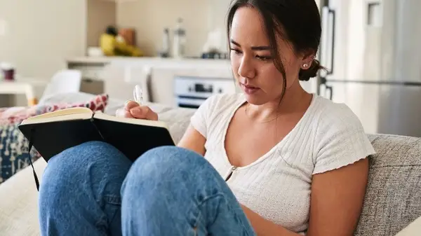 Woman writing down goals