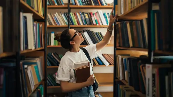 Woman in library browsing