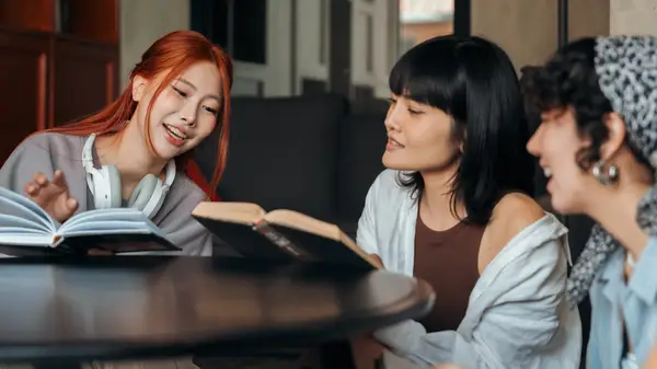 A group of friends reading a book