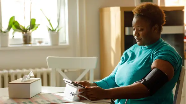 woman taking blood pressure reading