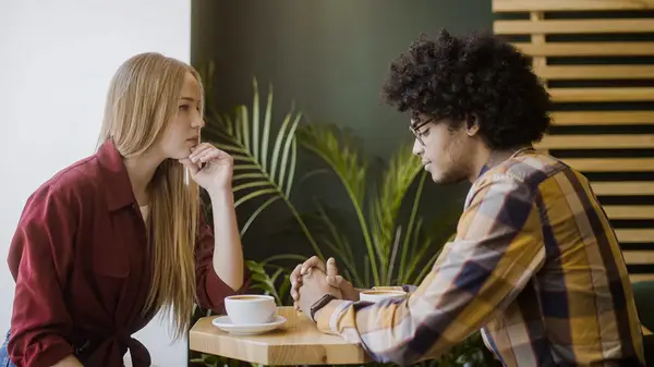 Two people in tense conversation