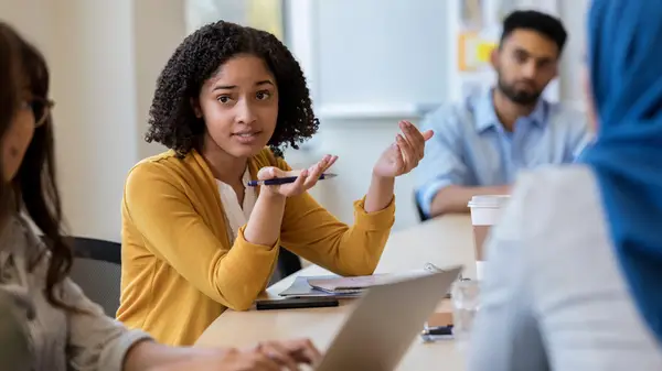 Woman asking question in meeting