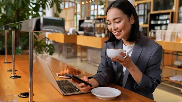 Woman on phone at cafe