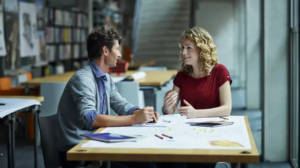 Two people talking in office