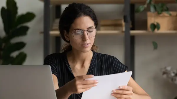 Woman with paper at desk