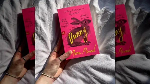 A hand holding the novel 